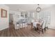 Well-lit kitchen featuring white cabinets, stainless steel appliances, and stylish dining area with a wooden table at 113 Amaranth Ave, Summerville, SC 29483