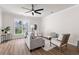 Bright living room features hardwood floors, a ceiling fan, and natural light through a large window at 113 Amaranth Ave, Summerville, SC 29483