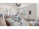 Cozy living room with comfortable seating, a ceiling fan, and lots of natural light from the surrounding windows at 113 Amaranth Ave, Summerville, SC 29483