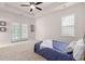 Bright primary bedroom features a large bed, French doors, and plenty of natural light at 113 Amaranth Ave, Summerville, SC 29483