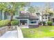 Charming backyard and patio featuring a grassy area with mature trees that provide shade and sliding glass doors at 1136 Shadow Lake Cir, Mount Pleasant, SC 29464