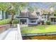 Charming backyard and patio featuring a grassy area with mature trees that provide shade and sliding glass doors at 1136 Shadow Lake Cir, Mount Pleasant, SC 29464