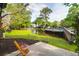 Inviting backyard with a wooden bridge over a pond, a well-maintained lawn, and mature trees at 1136 Shadow Lake Cir, Mount Pleasant, SC 29464