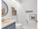 Bright bathroom featuring a blue-trimmed mirror, unique shelving, and decorative towel rack for added charm at 1136 Shadow Lake Cir, Mount Pleasant, SC 29464