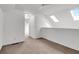 Upstairs bedroom with a ceiling fan and skylights providing plenty of natural light, painted in white at 1136 Shadow Lake Cir, Mount Pleasant, SC 29464