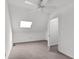 Bedroom featuring a ceiling fan, skylights, neutral carpeting, and an access door to a bathroom at 1136 Shadow Lake Cir, Mount Pleasant, SC 29464
