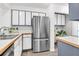 Well-lit kitchen featuring stainless steel appliances, wooden countertops, and white cabinetry at 1136 Shadow Lake Cir, Mount Pleasant, SC 29464