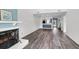Open living space with fireplace, hardwood floors, stylish light fixtures, and view to the kitchen at 1136 Shadow Lake Cir, Mount Pleasant, SC 29464