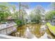 Peaceful water view from a private deck with multiple chairs and gazebo with mature trees reflecting on the water at 1136 Shadow Lake Cir, Mount Pleasant, SC 29464