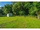 Large backyard featuring a storage shed and chain link fence at 115 W Park Ln, Summerville, SC 29486