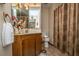 Cozy bathroom featuring a vanity and shower with a patterned curtain and decorative accents at 115 W Park Ln, Summerville, SC 29486