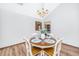 Bright dining area features a round table, modern chandelier, and wood floors at 115 W Park Ln, Summerville, SC 29486