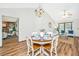 Charming dining area featuring a round table, hardwood floors, and a modern light fixture at 115 W Park Ln, Summerville, SC 29486