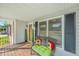 Inviting covered front porch with seating, decor, and a view of the home's entrance at 115 W Park Ln, Summerville, SC 29486