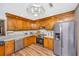 Well-lit kitchen features stainless steel appliances, updated countertops, and beautiful wood cabinets at 115 W Park Ln, Summerville, SC 29486