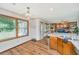 Kitchen area featuring natural light, wood flooring, breakfast bar and stainless steel trash receptacle at 115 W Park Ln, Summerville, SC 29486