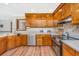 Functional kitchen with stainless steel appliances, tile backsplash, and wooden cabinetry at 115 W Park Ln, Summerville, SC 29486