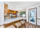 Bright kitchen features a large island with seating, stainless steel appliances, and wood cabinets at 115 W Park Ln, Summerville, SC 29486