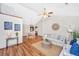 Open living space showcases the hardwood floors, ceiling fan, decor, and access to dining area at 115 W Park Ln, Summerville, SC 29486