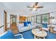 Open living room with hardwood floors, large windows, and views of the adjacent kitchen at 115 W Park Ln, Summerville, SC 29486