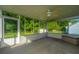 Covered screened porch with a ceiling fan and great views of the treed yard at 115 W Park Ln, Summerville, SC 29486