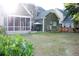 Backyard view of the home with a covered porch, patio area, and lush green lawn at 116 Marshside Dr, Summerville, SC 29485
