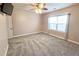 Bedroom with plush carpet, ceiling fan and light, and a large window at 116 Marshside Dr, Summerville, SC 29485