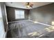 This bedroom features a ceiling fan, plush carpet, and a large window at 116 Marshside Dr, Summerville, SC 29485