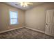 Bedroom with bright window features plush carpet, a ceiling fan, and one door at 116 Marshside Dr, Summerville, SC 29485