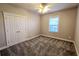 Neutral bedroom features plush carpet, a ceiling fan, and bright window at 116 Marshside Dr, Summerville, SC 29485