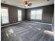 This bedroom features a ceiling fan, plush carpet, and three windows at 116 Marshside Dr, Summerville, SC 29485
