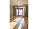 Sun-filled dining room with hardwood floors, bay window, and classic chandelier at 116 Marshside Dr, Summerville, SC 29485