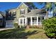 Beautiful home with an inviting front porch, attached garage, and lush green lawn at 116 Marshside Dr, Summerville, SC 29485