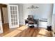 Bright home office with gleaming wood floors, desk, and French doors to maximize the natural light at 116 Marshside Dr, Summerville, SC 29485