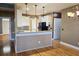 Stylish kitchen boasts white cabinetry, a breakfast bar with granite countertop, pendant lights, and stainless-steel appliances at 116 Marshside Dr, Summerville, SC 29485
