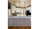 Charming kitchen features white cabinets, breakfast bar, granite countertops, pendant lighting, and modern appliances at 116 Marshside Dr, Summerville, SC 29485