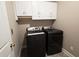 Laundry room with washer and dryer and overhead cabinets at 116 Marshside Dr, Summerville, SC 29485
