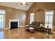 Spacious living room with hardwood floors, fireplace, large windows, and vaulted ceiling is perfect for gatherings at 116 Marshside Dr, Summerville, SC 29485