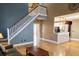 Sun-filled living room featuring hardwood floors, open staircase and a view into the kitchen area, great for entertaining at 116 Marshside Dr, Summerville, SC 29485