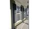 Covered porch showcasing classic columns and elegant black shutters at 116 Marshside Dr, Summerville, SC 29485