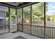 The screened-in porch overlooks the private backyard with mature trees at 116 Marshside Dr, Summerville, SC 29485