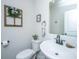 Half bathroom with decorative mirror, toilet, sink, faucet, and decorative fixtures at 119 Lucca Dr, Summerville, SC 29486