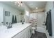 Well-lit bathroom with double sinks, white countertops, black fixtures, and a tub/shower combination at 119 Lucca Dr, Summerville, SC 29486