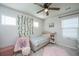 Charming bedroom featuring a light blue quilt, a cozy armchair, and decorative vines adorning the wall at 119 Lucca Dr, Summerville, SC 29486