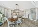 Open-concept dining area featuring a stylish chandelier, staircase, and modern design at 119 Lucca Dr, Summerville, SC 29486