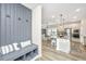 Inviting entryway features a built-in bench, storage, coat hooks, and a glimpse into the modern kitchen at 119 Lucca Dr, Summerville, SC 29486