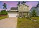Charming two-story home with a well-manicured lawn, inviting curb appeal, and an attached two-car garage at 119 Lucca Dr, Summerville, SC 29486
