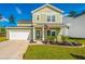 Two-story home with a well-manicured front yard, driveway, and American flag at 119 Lucca Dr, Summerville, SC 29486