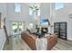 Open-concept living room with high ceilings, a cozy fireplace, and an abundance of natural light at 119 Lucca Dr, Summerville, SC 29486