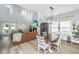 Cozy living room with high ceilings, fireplace, large windows, and an adjacent dining area at 119 Lucca Dr, Summerville, SC 29486